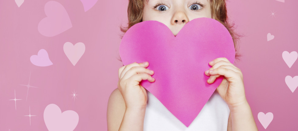 Preschool girl holding paper heart